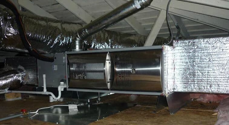 HVAC system with ducts in an attic, showcasing insulation and ventilation components.